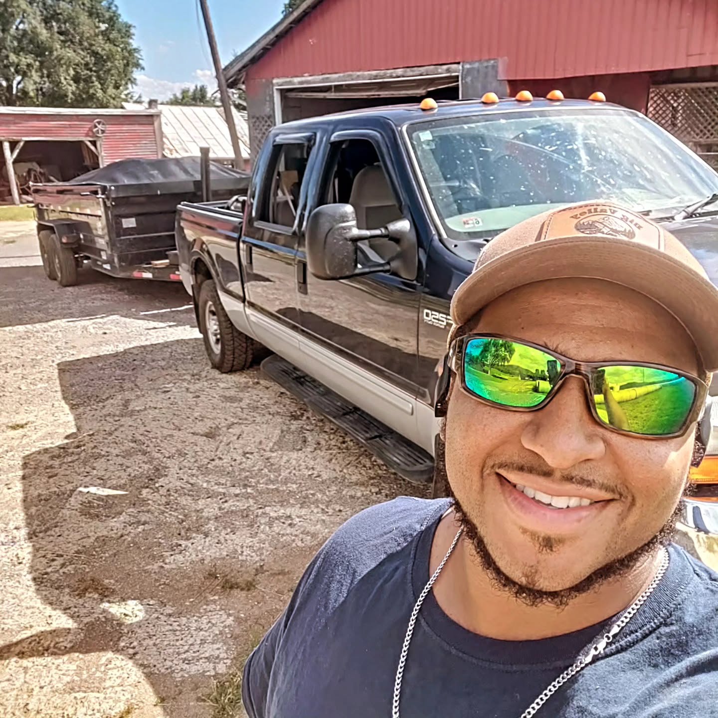The owner of Big Valley Junk Removal with his truck and dump trailer